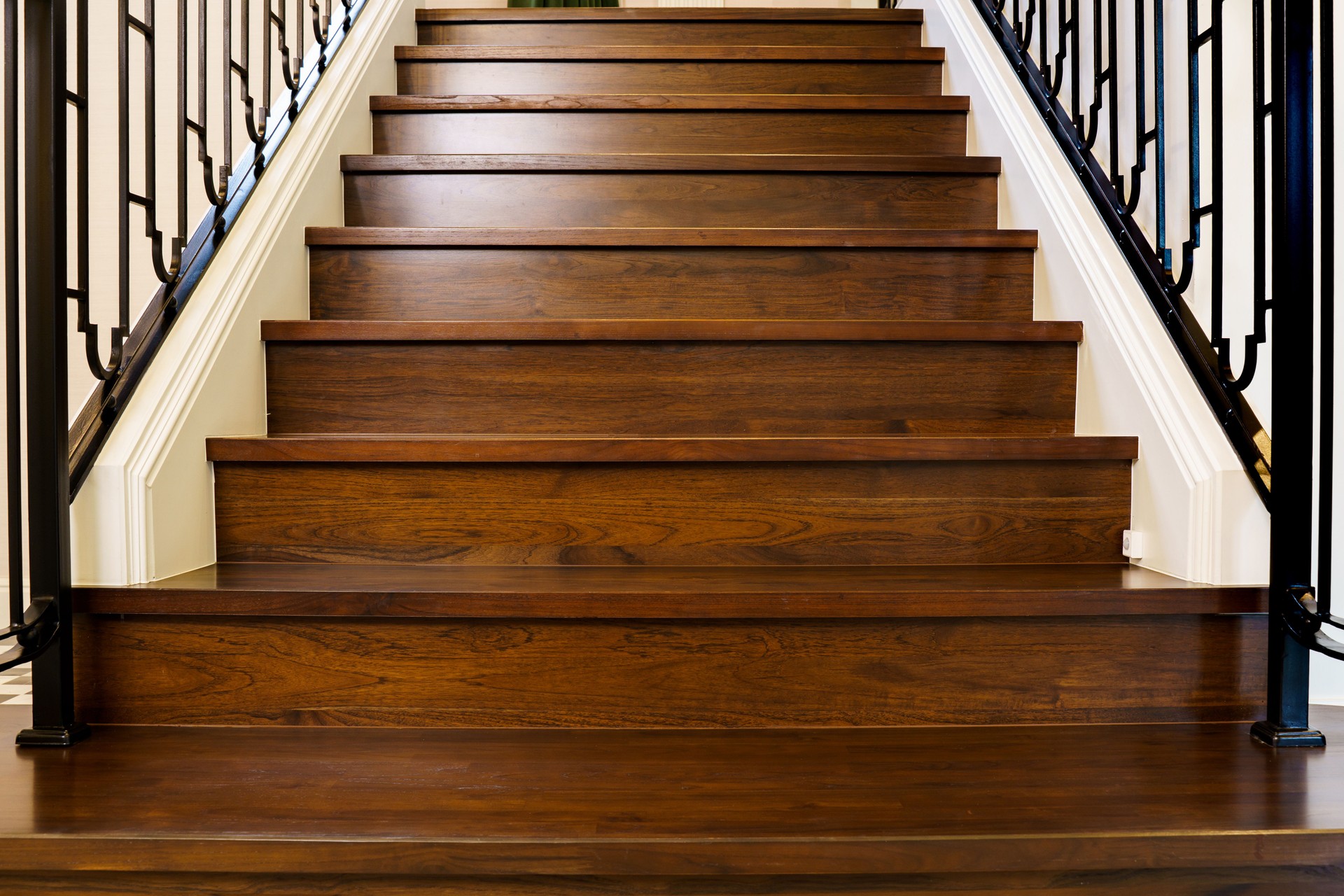 Dark teak wood staircase with detailed texture, perfect for interior design and architectural backgrounds.